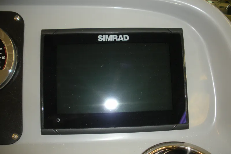 Slide: The Image of Simrad display on 2026 Robalo R207 Dual Console boat dashboard. - 7