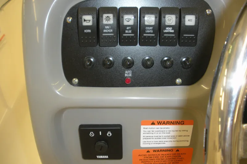 Slide: The Image of Control panel of 2026 Robalo R207 Dual Console boat with warning labels. - 8