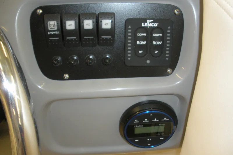 Slide: The Image of Control panel of 2026 Robalo R207 Dual Console boat with switches and Lenco trim tab controls. - 9