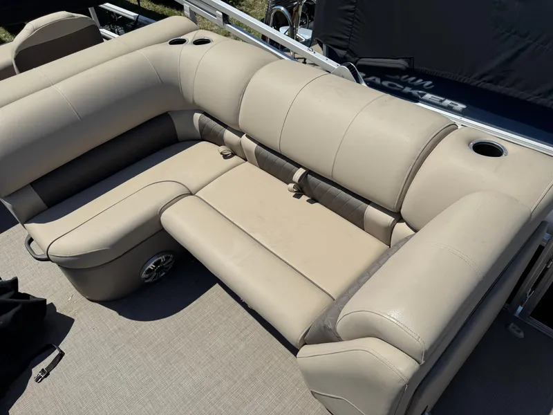 Slide: The Image of Beige seating on 2023 Sun Tracker SportFish 22 DLX pontoon boat, featuring cup holders. - 11
