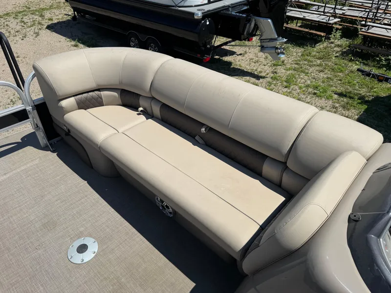Slide: The Image of 2023 Sun Tracker SportFish 22 DLX boat with beige cushioned seating. - 8