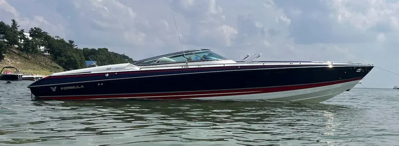 Slide: The Image of 2017 Formula 353 FASTech boat on calm water, sleek design, overcast sky. - 0