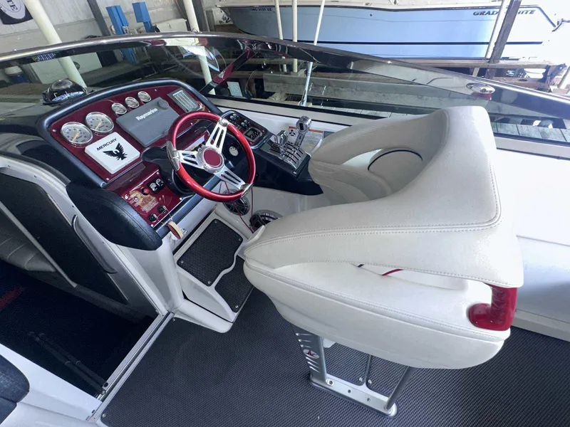 Slide: The Image of 2017 Formula 353 FASTech boat cockpit with red steering wheel and white seating. - 26