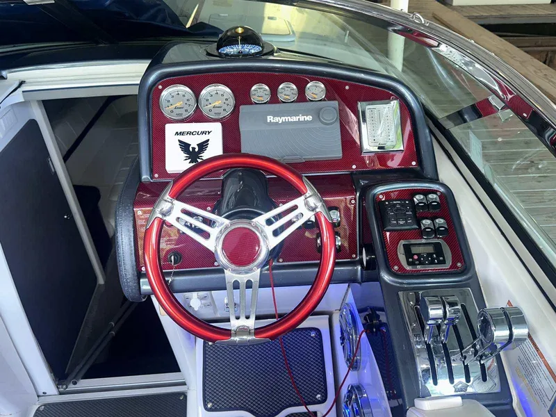 Slide: The Image of 2017 Formula 353 FASTech boat dashboard with red steering wheel and control panel. - 29
