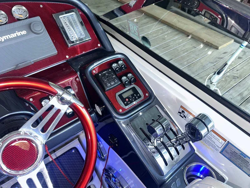 Slide: The Image of 2017 Formula 353 FASTech boat dashboard with red accents and advanced controls. - 30