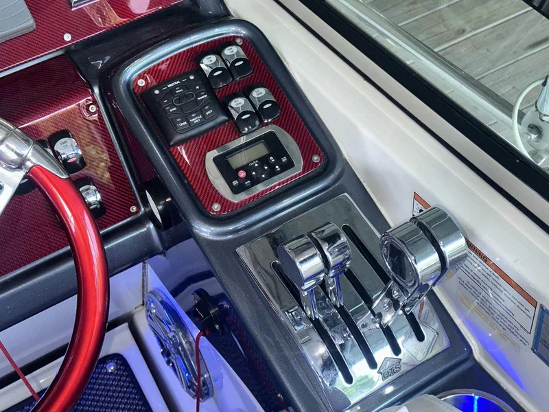 Slide: The Image of Control panel of a 2017 Formula 353 FASTech boat with chrome levers and red accents. - 31