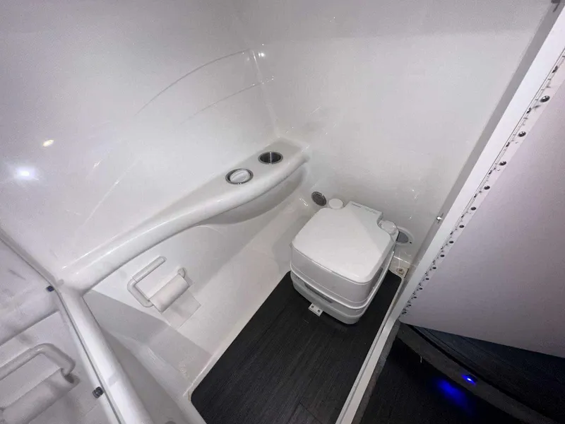 Slide: The Image of 2017 Formula 353 FASTech boat bathroom with compact toilet and sleek white interior. - 45