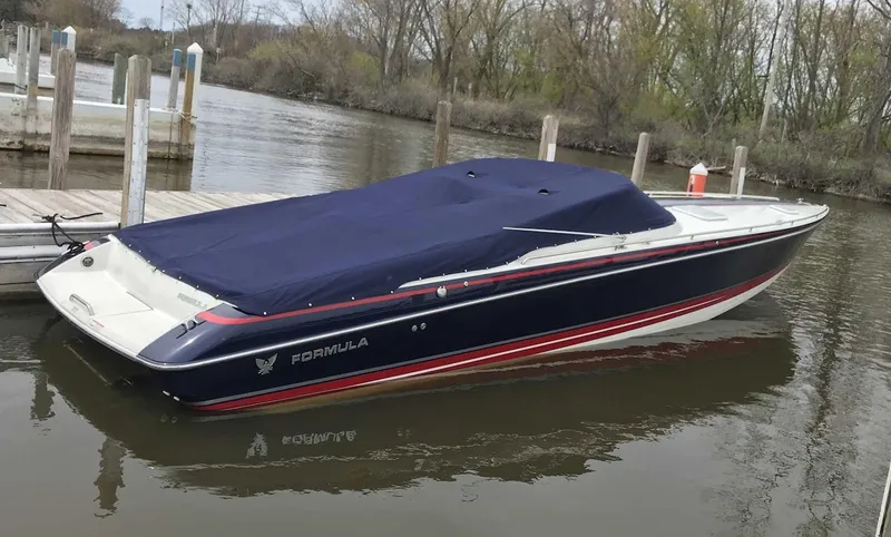 Slide: The Image of 2017 Formula 353 FASTech boat docked with cover, in a calm water setting. - 7