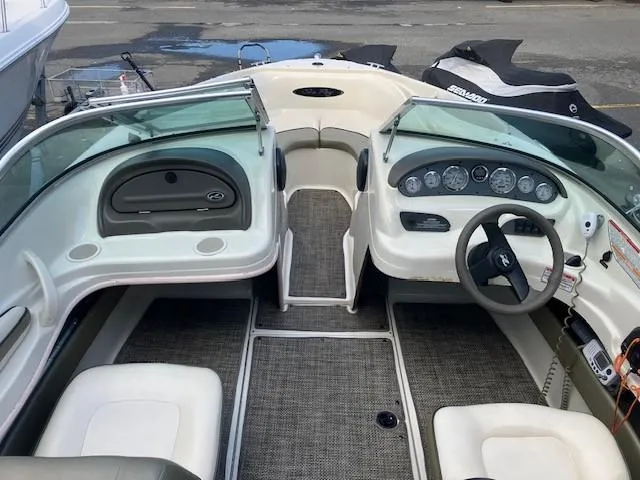 Slide: The Image of 2005 Sea Ray 185 Sport boat interior with steering wheel and dashboard controls. - 2