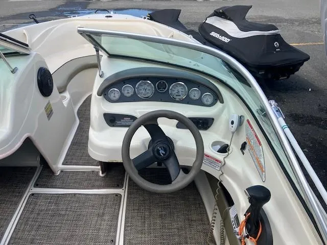 Slide: The Image of 2005 Sea Ray 185 Sport boat dashboard with steering wheel and gauges. - 6