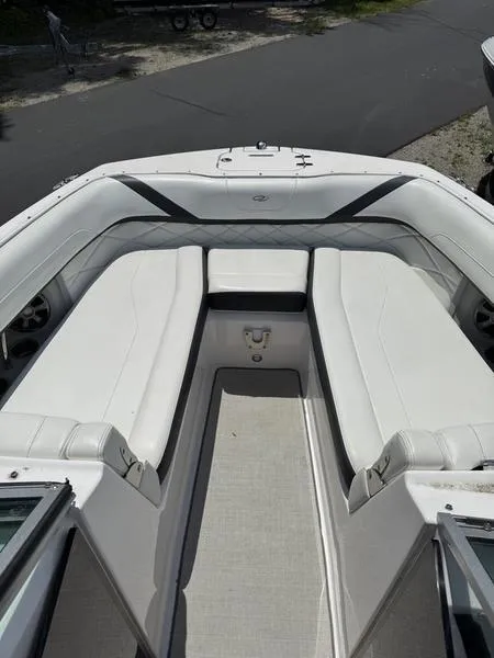 Slide: The Image of 2020 Regal 26 OBX boat interior with white seating and open deck. - 4