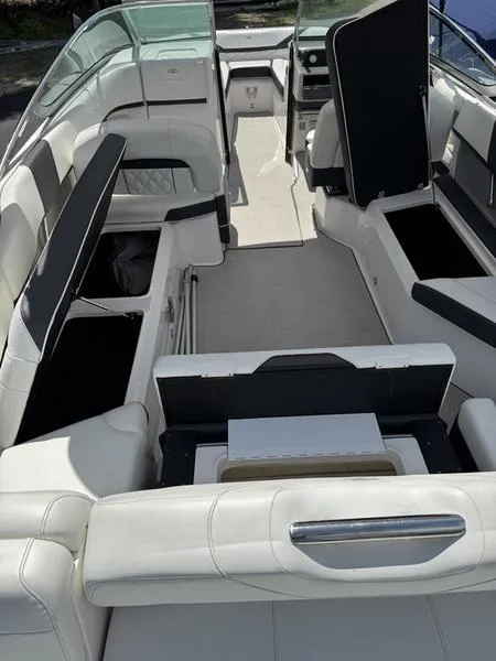 Slide: The Image of 2020 Regal 26 OBX boat interior with white seating and storage compartments. - 7