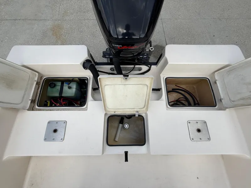 Slide: The Image of 2006 Pathfinder 2200v boat compartments with open hatches and visible engine components. - 14