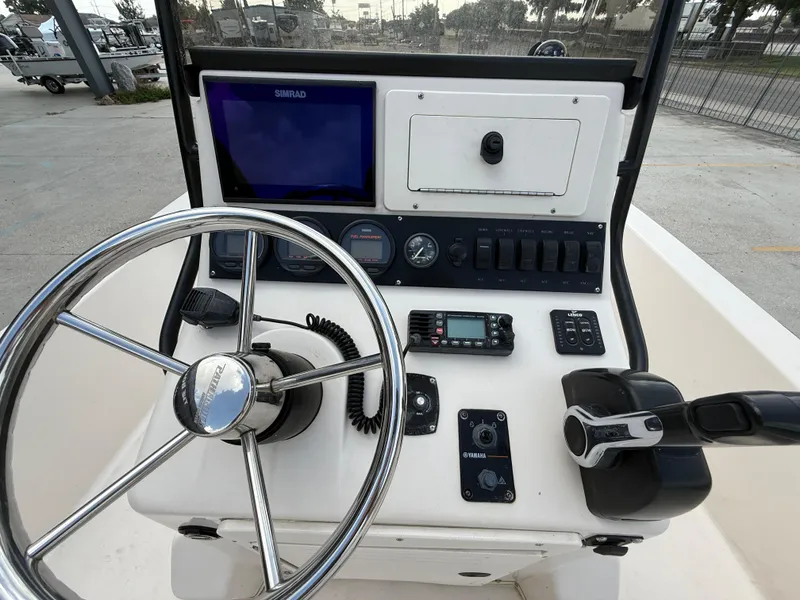 Slide: The Image of 2006 Pathfinder 2200v boat console with steering wheel, controls, and navigation equipment. - 15