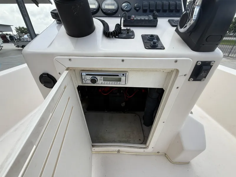 Slide: The Image of 2006 Pathfinder 2200v boat console with open storage compartment and control panel. - 16
