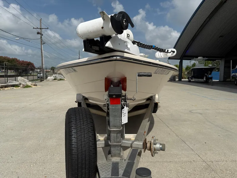 Slide: The Image of 2006 Pathfinder 2200v boat on trailer, parked outdoors under a partly cloudy sky. - 3