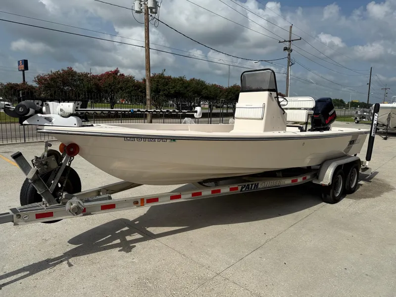 Slide: The Image of 2006 Pathfinder 2200v boat on trailer, parked outdoors under cloudy sky. - 4