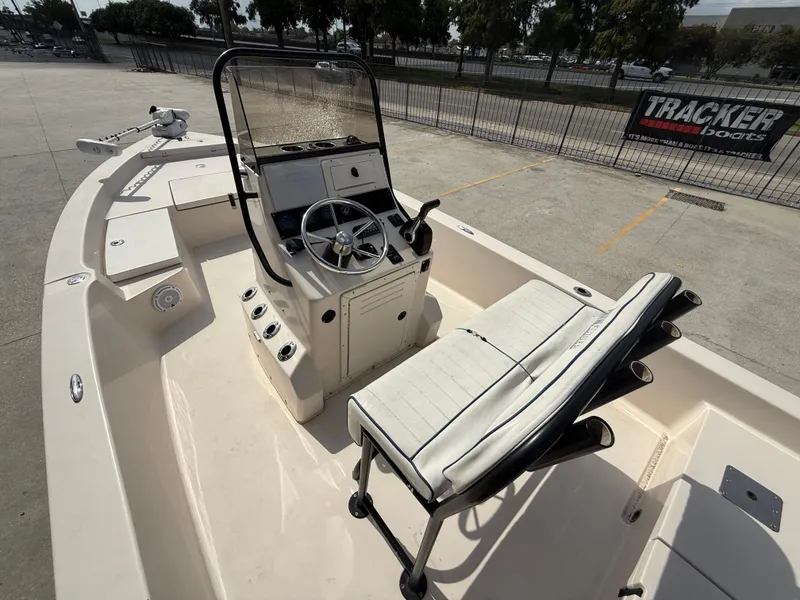 Slide: The Image of 2006 Pathfinder 2200v boat interior with steering console and seating, parked outdoors. - 9