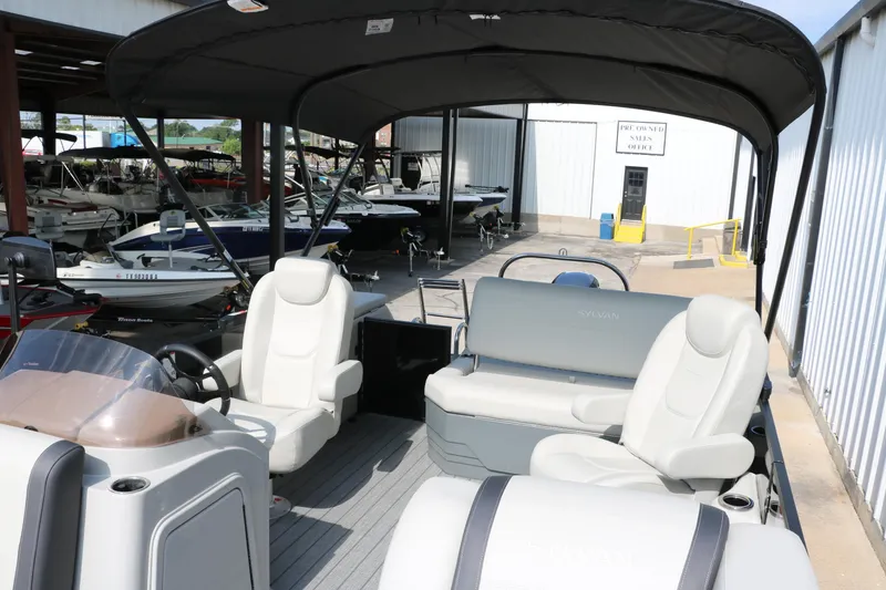 Slide: The Image of 2026 Sylvan Mirage Cruise 8520 CLZ DH pontoon boat interior with seating and canopy. - 14