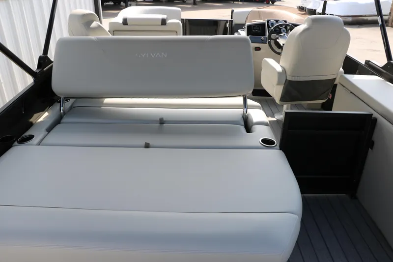 Slide: The Image of 2026 Sylvan Mirage Cruise 8520 CLZ DH interior with plush seating and modern helm. - 16