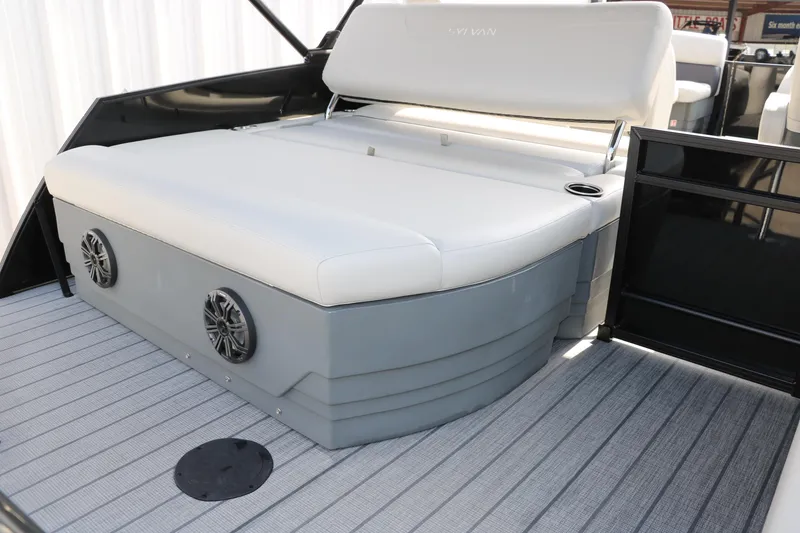 Slide: The Image of 2026 Sylvan Mirage Cruise 8520 CLZ DH boat interior with cushioned seating and speakers. - 17