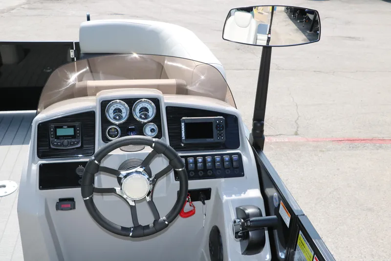 Slide: The Image of 2026 Sylvan Mirage Cruise 8520 CLZ DH boat dashboard with steering wheel and controls. - 20