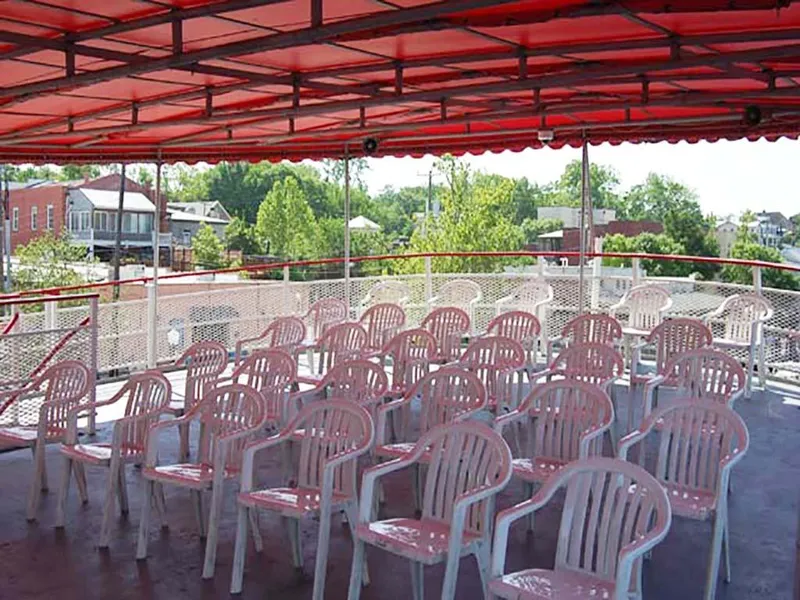 Slide: The Image of Upper deck of 1985 Custom Serodino Dinner Boat with white chairs and red canopy. - 13
