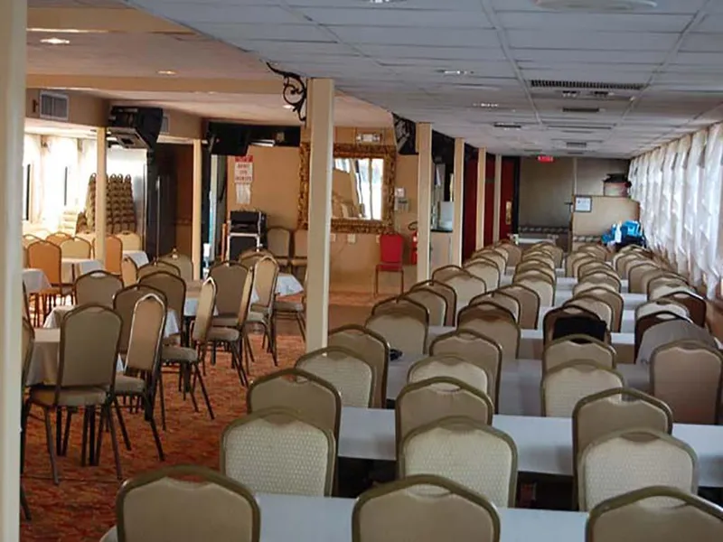 Slide: The Image of Interior of 1985 Custom Serodino Dinner Boat with rows of tables and chairs. - 14