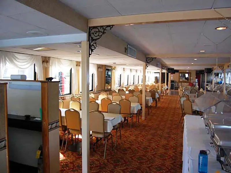 Slide: The Image of Interior of 1985 Custom Serodino Dinner Boat with elegant dining setup and ornate decor. - 15