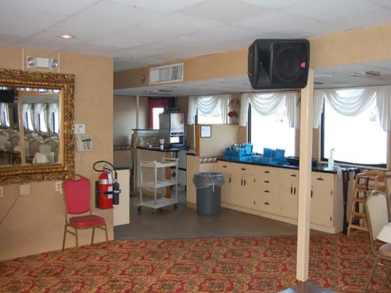 Slide: The Image of Interior of 1985 Custom Serodino Dinner Boat with ornate mirror, red chair, and patterned carpet. - 17