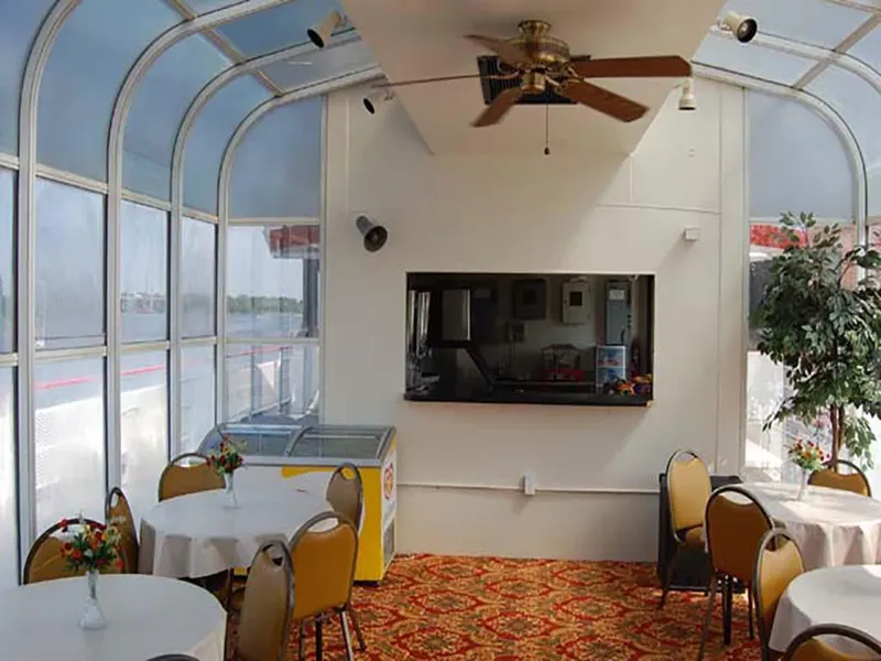 Slide: The Image of Interior of 1985 Custom Serodino Dinner Boat with tables, chairs, and ceiling fan. - 19