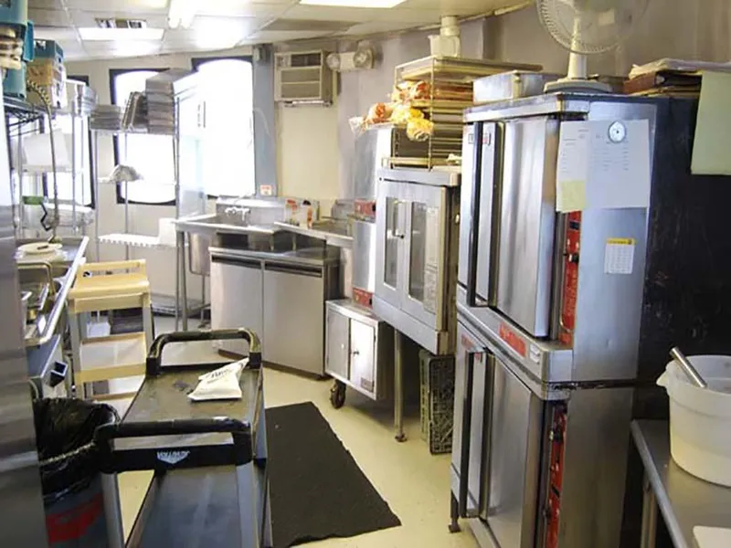 Slide: The Image of Kitchen interior of 1985 Custom Serodino Dinner Boat with stainless steel appliances and equipment. - 23