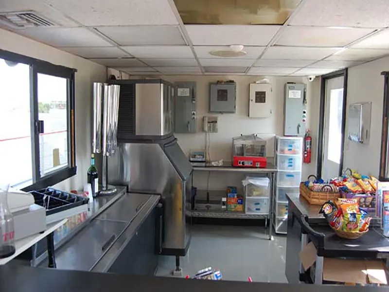 Slide: The Image of Interior of a 1985 Custom Serodino Dinner Boat kitchen with snacks and equipment. - 26
