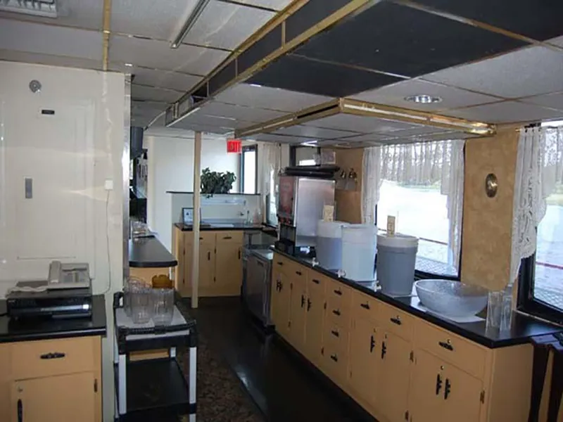 Slide: The Image of Interior of 1985 Custom Serodino Dinner Boat with kitchen and dining setup. - 28
