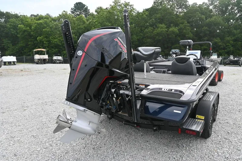 Slide: The Image of 2025 Caymas CX 19 boat with powerful outboard motor, parked on gravel lot. - 4