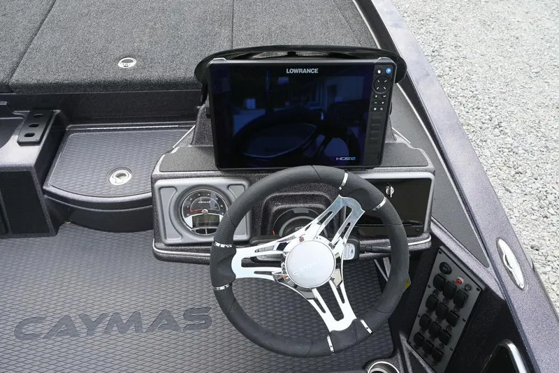 Slide: The Image of 2025 Caymas CX 19 boat dashboard with steering wheel and Lowrance display. - 8
