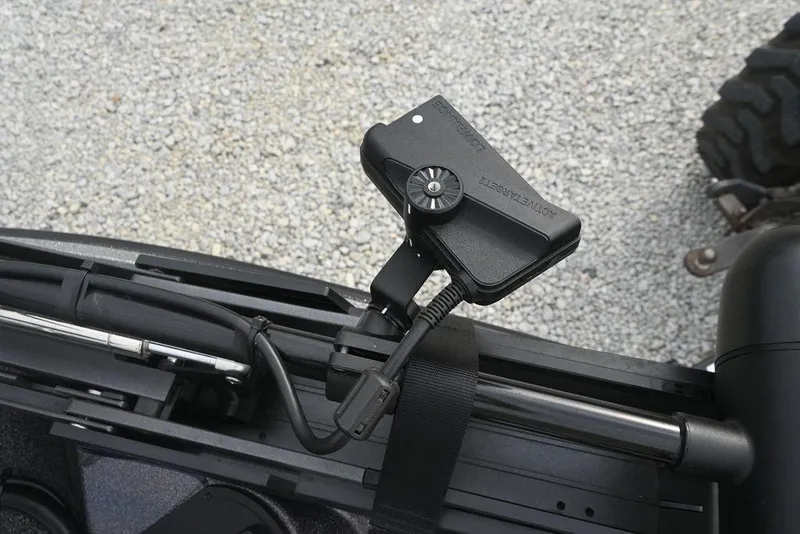 Slide: The Image of Close-up of a 2025 Caymas CX 19 boat component with a mounted device on a textured surface. - 9