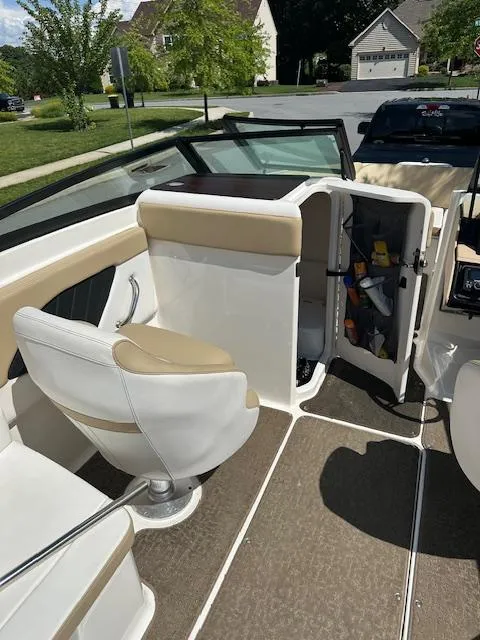 Slide: The Image of 2018 Sea Ray SPX 230 boat interior with seating and storage compartment. - 10