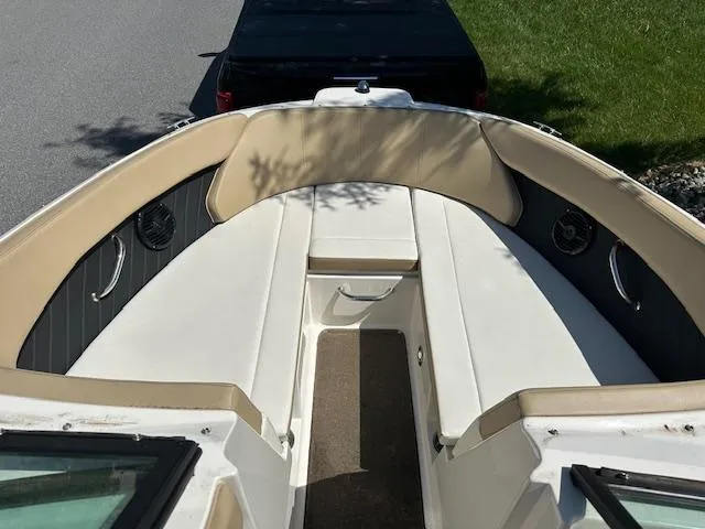 Slide: The Image of 2018 Sea Ray SPX 230 boat interior with beige seating and black accents. - 12