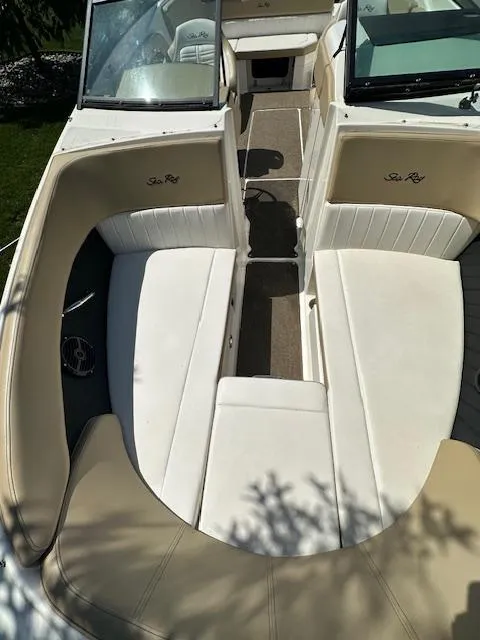Slide: The Image of 2018 Sea Ray SPX 230 boat interior with white seating and open deck layout. - 13