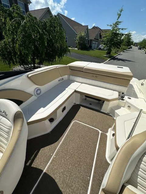 Slide: The Image of 2018 Sea Ray SPX 230 boat interior with beige seating and carpeted floor. - 6