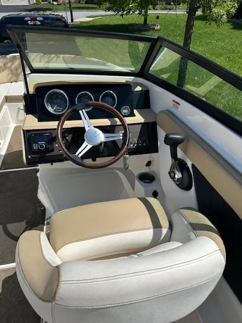 Slide: The Image of 2018 Sea Ray SPX 230 boat interior with steering wheel and dashboard controls. - 9