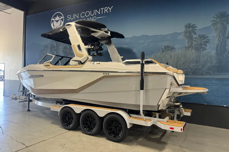 Slide: The Image of 2026 Nautique Super Air Nautique G23 Paragon boat on trailer in showroom. - 2