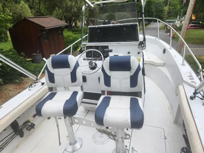 Slide: The Image of 1996 Boston Whaler 21 Outrage boat interior with dual captain chairs and steering console. - 4