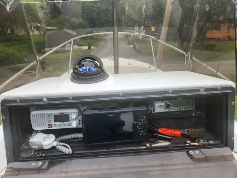 Slide: The Image of 1996 Boston Whaler 21 Outrage dashboard with compass, Garmin GPS, and radio equipment. - 5