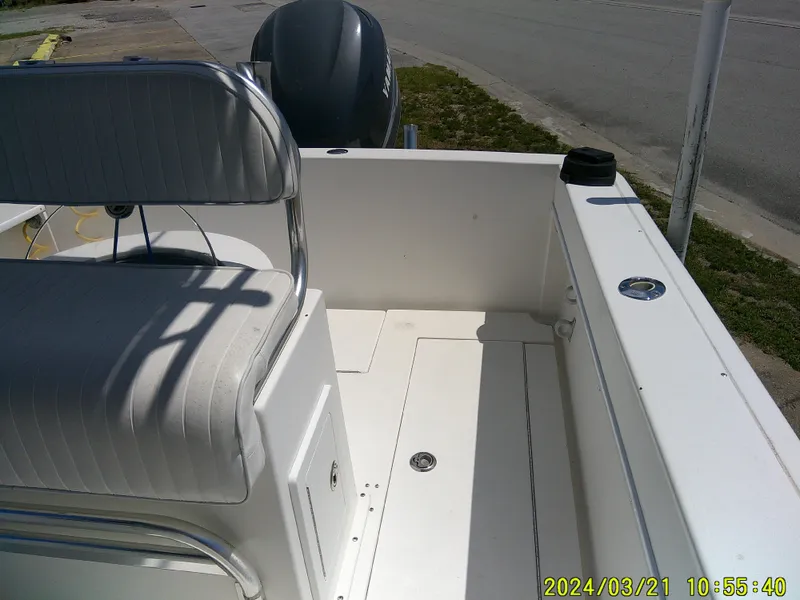 Slide: The Image of 2004 Contender 23 Open boat interior with seating and engine view. - 10