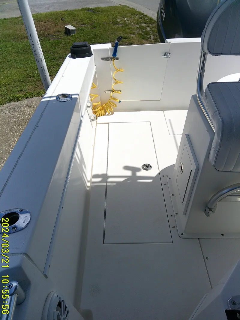 Slide: The Image of 2004 Contender 23 Open boat interior with seating and storage compartments. - 12