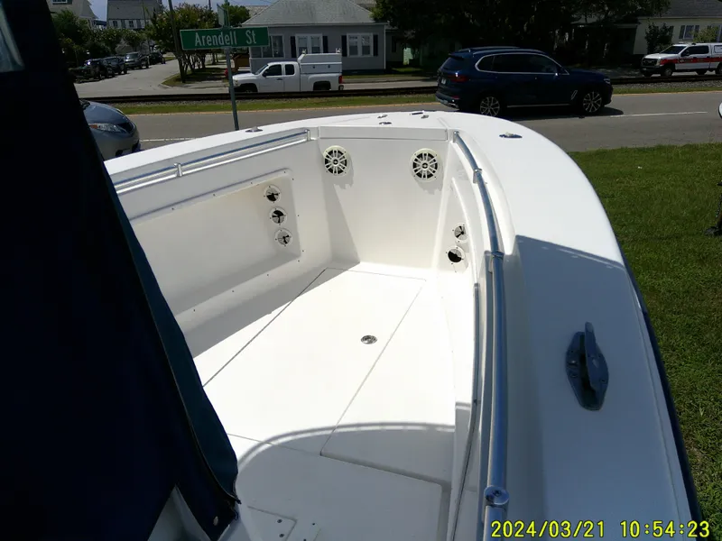 Slide: The Image of 2004 Contender 23 Open boat interior with speakers, parked near Arendell Street. - 18