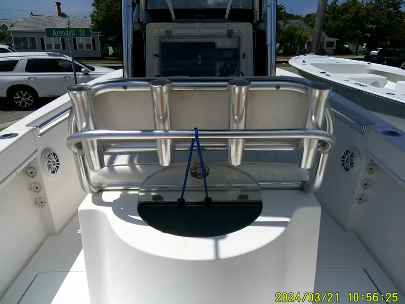 Slide: The Image of 2004 Contender 23 Open boat interior with rod holders and storage area. - 20