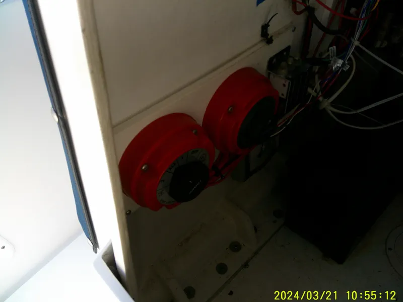 Slide: The Image of 2004 Contender 23 Open boat interior showing electrical components and wiring. - 28